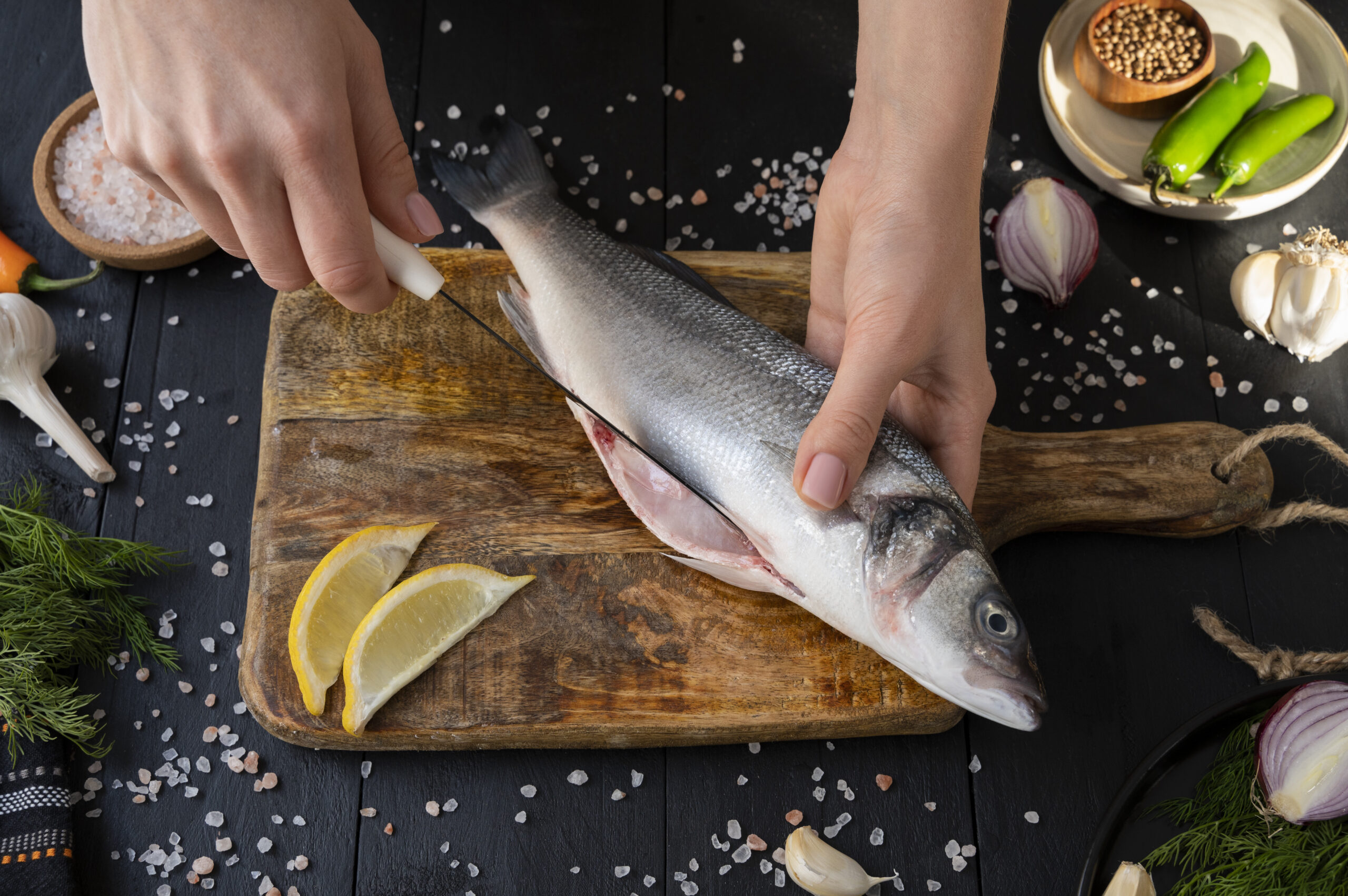 top-view-cook-cleaning-fish-kitchen